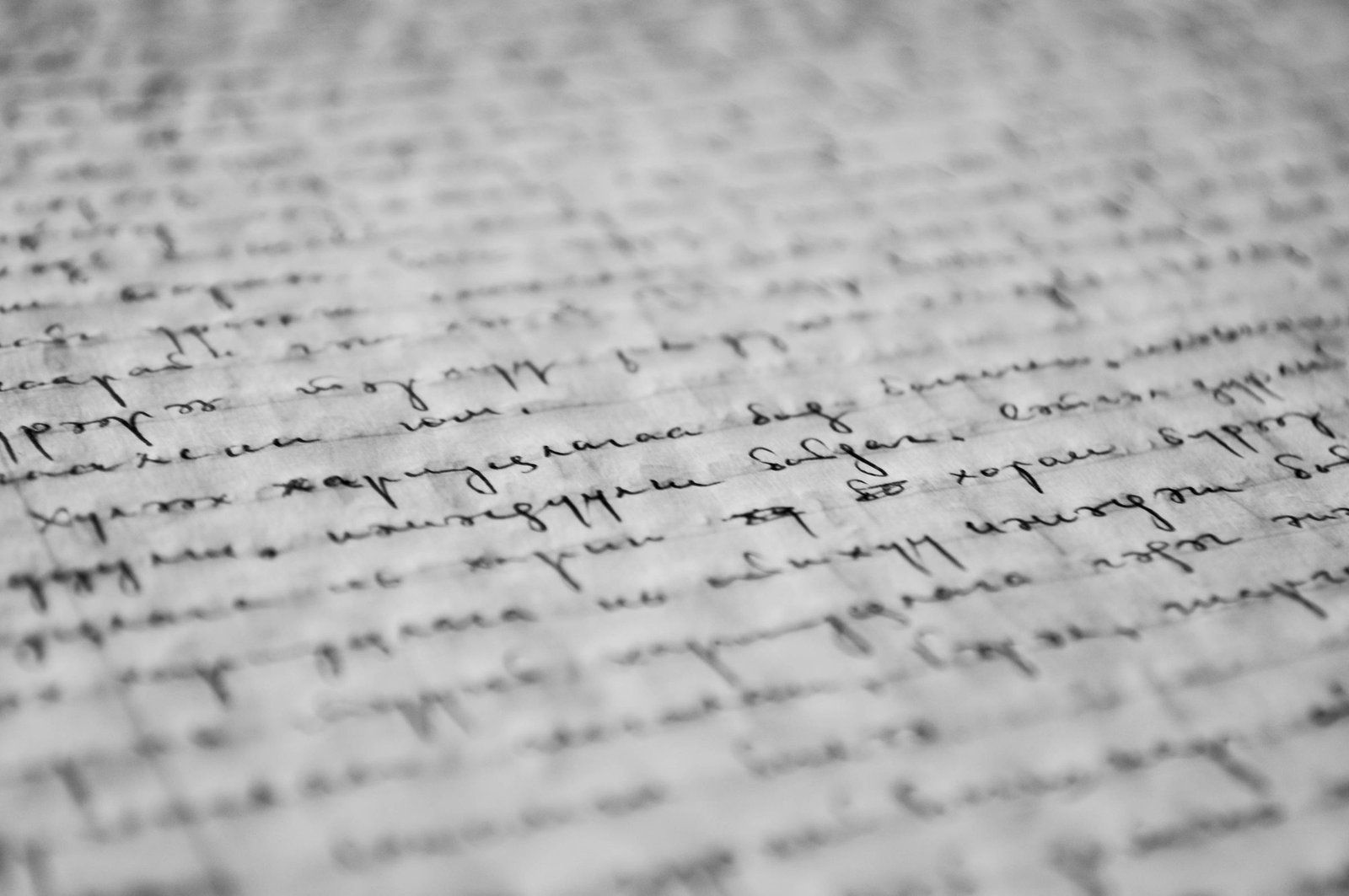 Open notebook and fountain pen on a wooden desk under a lamp